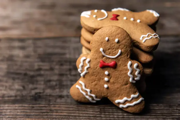 delicious Christmas gingerbread man cookies on wooden table