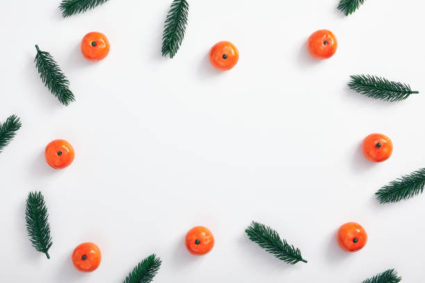 istock Christmas tree branch and tangerine 1186967639