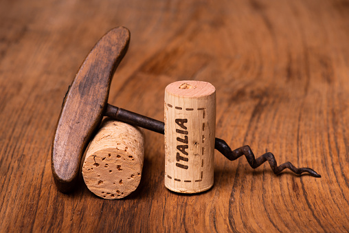 Close up of the removal of a cork from a wine bottle. The opener is the type which lifts the cork in two stages.