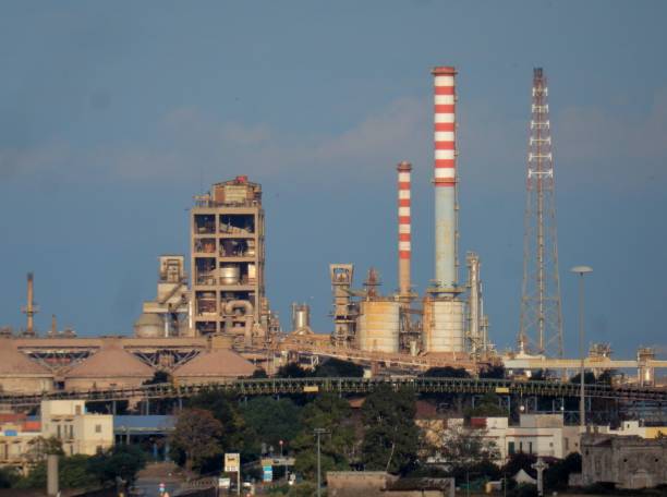 Taranto - Glimpse of the industrial area at dawn Taranto, Puglia, Italy - November 2, 2019: Chimneys of the Arcelor Mittal steel plant in the Tamburi district early in the morning taranto stock pictures, royalty-free photos & images