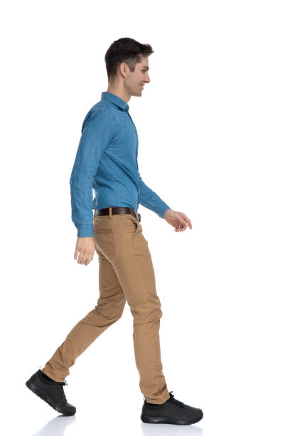 istock side view of smart casual man smiling and walking 1186973284