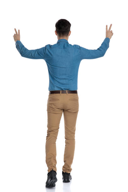 istock back view of smart casual man making peace sign 1186973400
