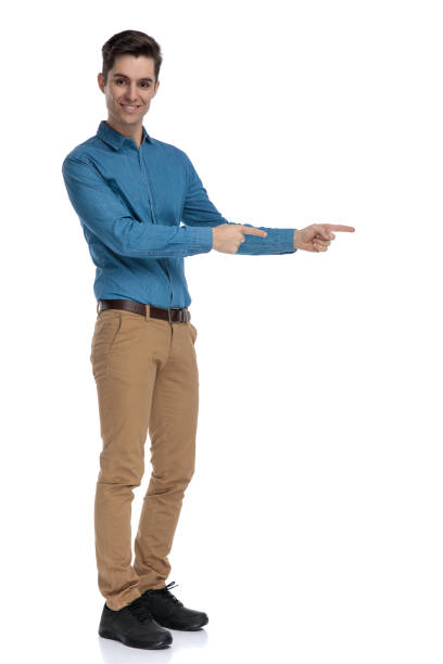 istock side view of happy young man pointing finger and smiling 1186973570