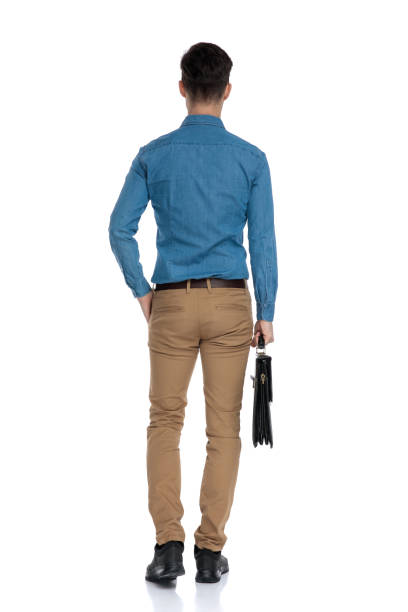 istock back view of smart casual man holding suitcase 1186973622