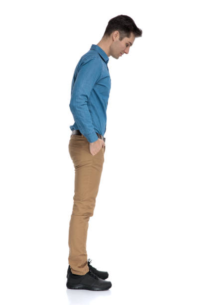 istock smart casual man waiting in line and looking down 1186973816