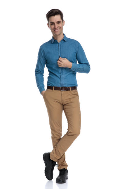 istock happy smart casual man arranging shirt and smiling 1186973890
