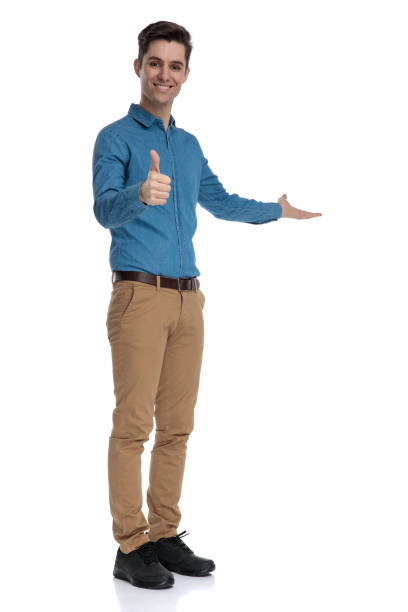istock young elegant man making thumbs up sign and presenting to side 1186974025
