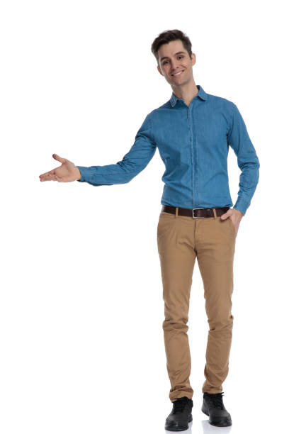 istock happy young man smiling and presenting to side 1186974675