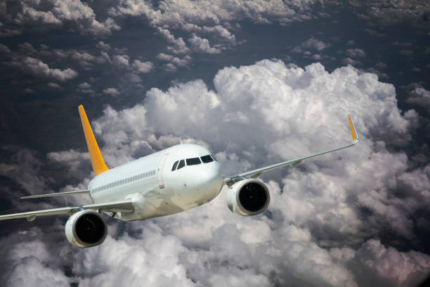 istock Commercial airplane flying above clouds 1186974712