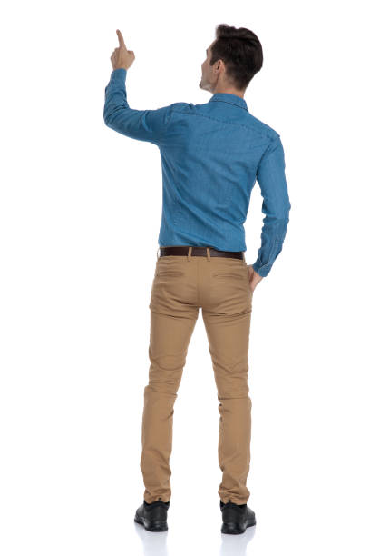 istock back view of smart casual man looking up and pointing finger 1186974882