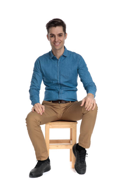 istock happy young man smiling and holding palms on knees 1186978874