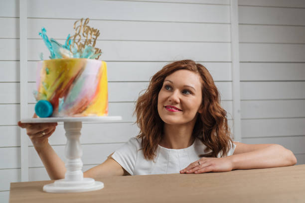 istock Female cake baker appraising her creation 1186979553