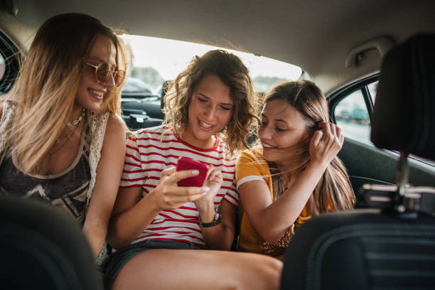 istock Female friendship in the back seats 1186979939