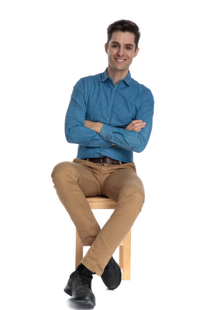 istock happy young man smiling and crossing arms 1186981263