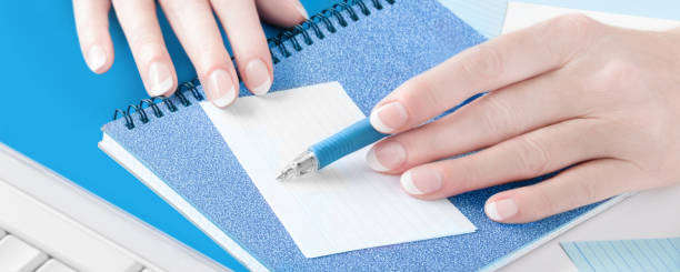 istock Female hands with pen and paper 1186981509