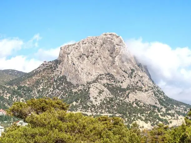 Photo of Summer view of mountain Sokol in the clouds.