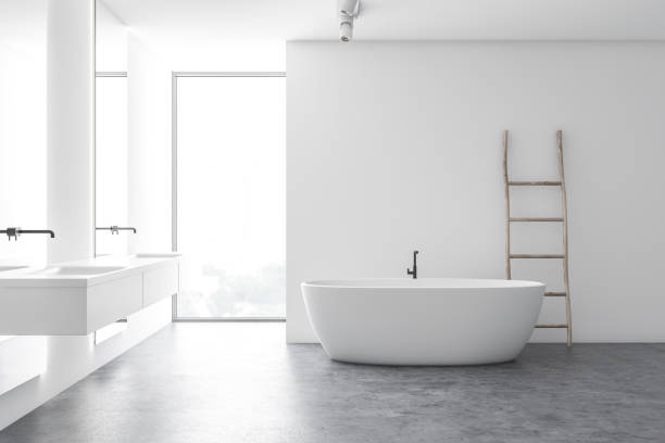 istock Modern white bathroom with tub and double sink 1186992477