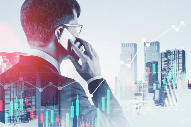 istock Broker talking on phone in city, digital charts 1186992579