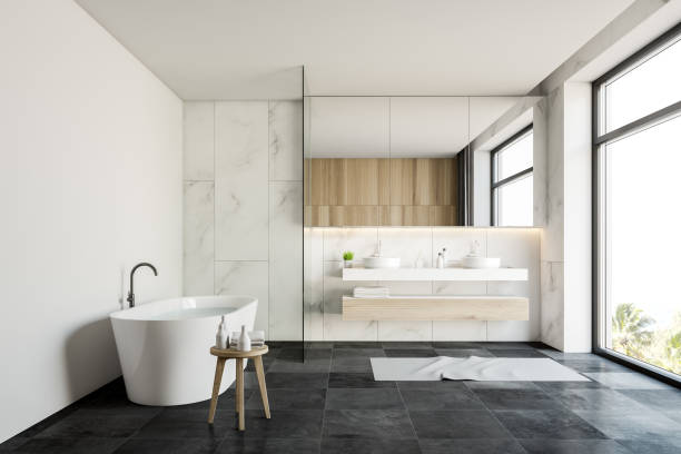 istock White marble bathroom interior with sink and tub 1186995162