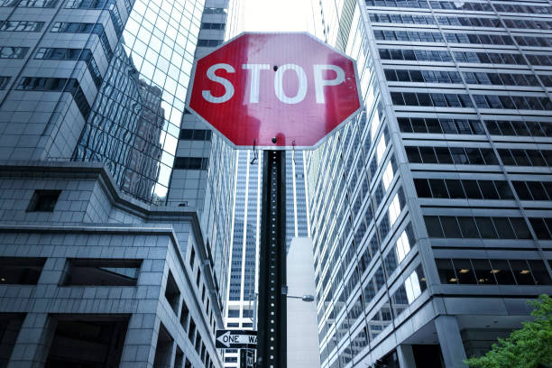 Close up stop sign and skyscraper in downtown Manhattan, New York