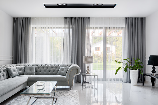 Interior of a modern cozy bedroom with furniture in pastel tones.