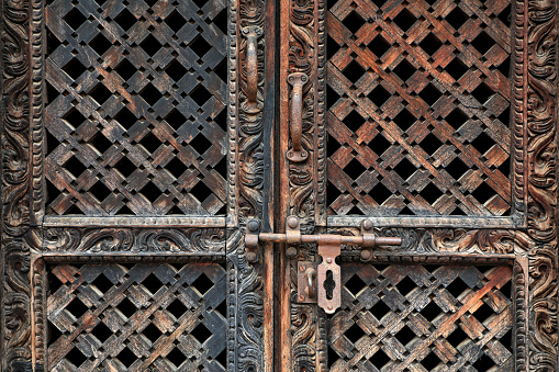 Close up old antique wooden door from Buddhist temple in Kathmandu, Nepal