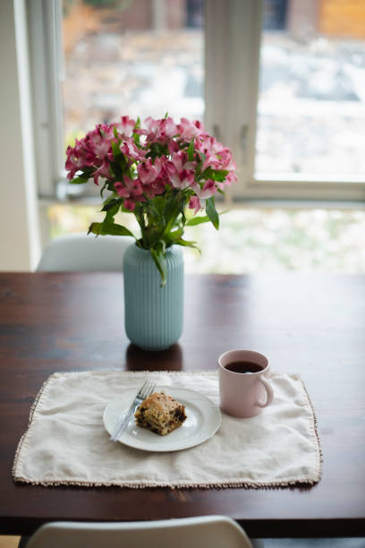 istock Cake, coffee and flowers on a table 1187001011