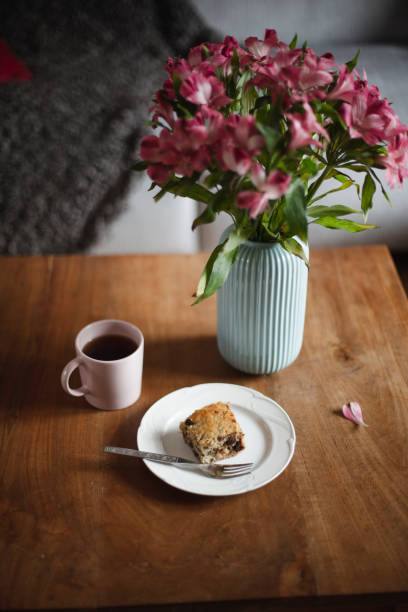 istock Cake, coffee and flowers on a table 1187001013