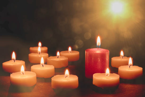 istock Many white candles ond one red candle. Bokeh and flares 1187001024