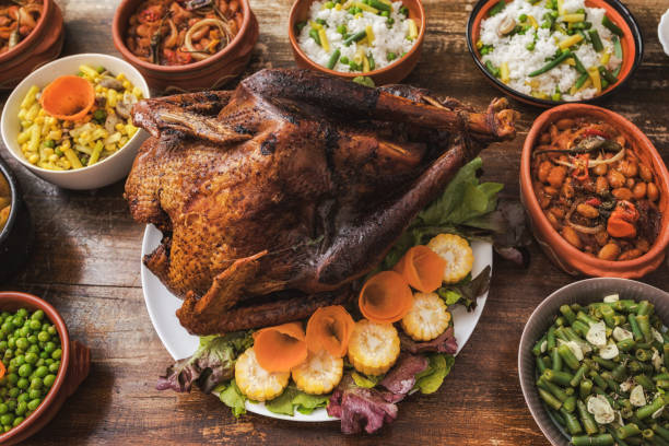 istock Thanksgiving dining, roast turkey with side dishes on table 1187001945