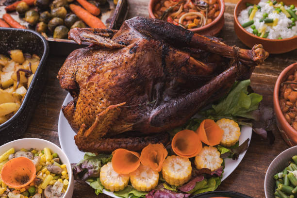 istock Thanksgiving dining, roast turkey with side dishes on table 1187003334