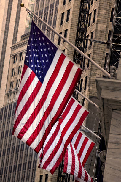 istock Close up American flags at building exterior 1187005660