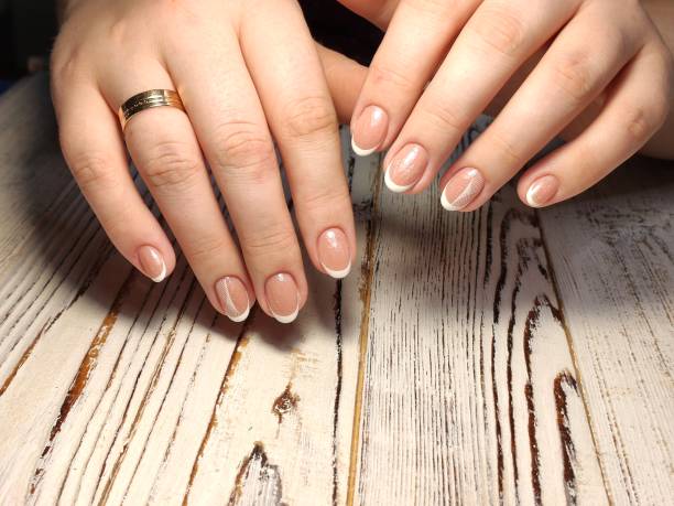 istock fashionable beige manicure with a silver design 1187005924