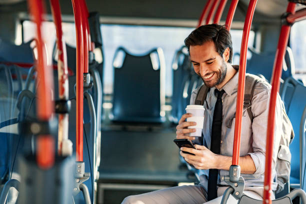 istock Businessman using smart phone inside of a bus 1187008218