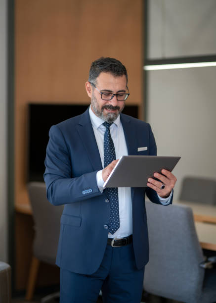 istock An office worker who actively uses social media, checking incoming data from his tablet during his standing coffee break 1187014384