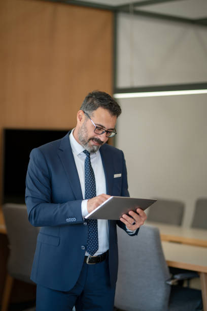 istock An office worker who actively uses social media, checking incoming data from his tablet during his standing coffee break 1187014439