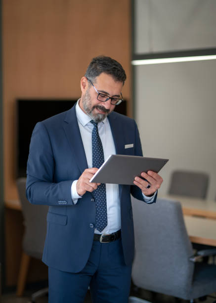 istock An office worker who actively uses social media, checking incoming data from his tablet during his standing coffee break 1187015655