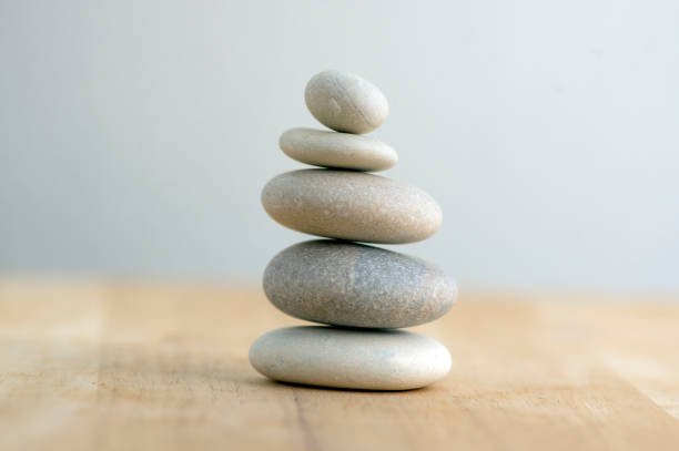 istock Stone cairn on striped grey white background, five stones tower, simple poise stones, simplicity harmony and balance, rock zen 1187015721