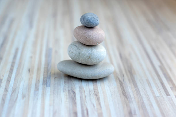 istock Stone cairn on striped grey white background, four stones tower, simple poise stones, simplicity harmony and balance, rock zen 1187015732