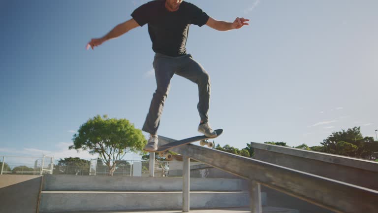 Stylish skateboarder grinding on a rail