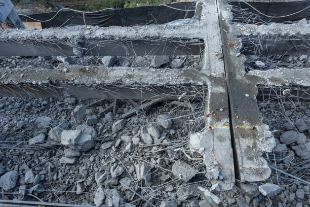 Construction rubble remains of a bridge being torn down Construction rubble remains of a bridge being torn down in a dense urban area deconstruct stock pictures, royalty-free photos & images
