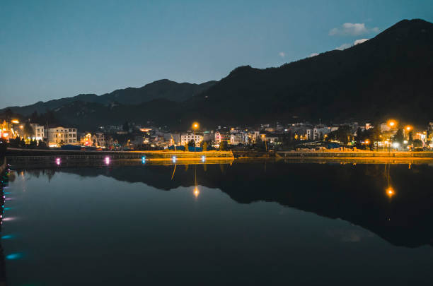 istock Night city landscape view with mountain background and cloudy sky reflection on water located at SAPA, Vietnam 1187019530