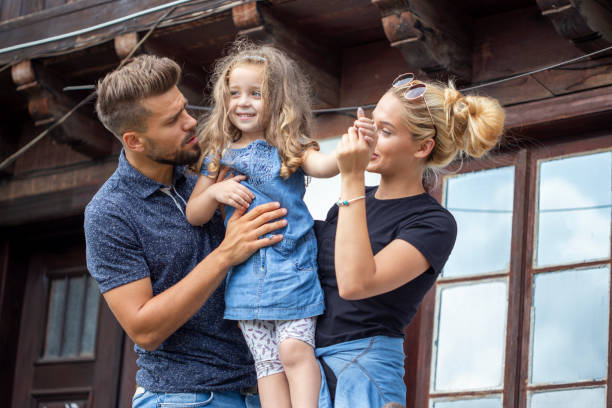 istock Happy family standing on the balcony 1187020059