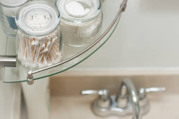 Cotton swabs organized in glass jars for the bathroom. stock photo