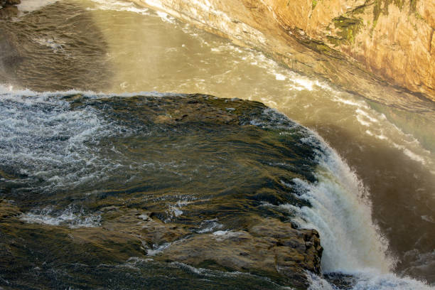 istock dramatic powerful river water crashing over a huge rock face 1187026040