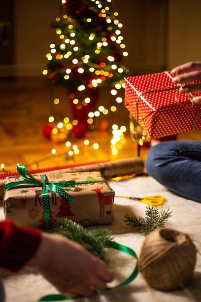 istock Decorating Christmas present with a pine cone spruce branch 1187026287