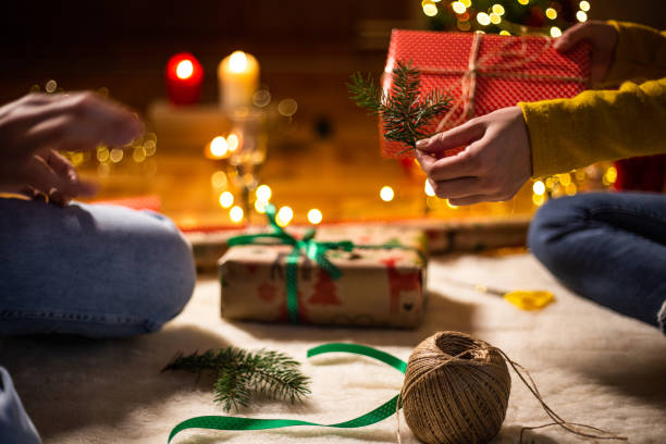istock Decorating Christmas present with a pine cone spruce branch 1187028415