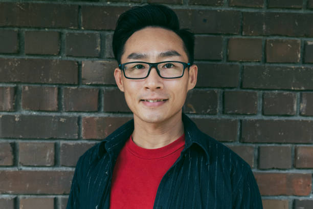istock Portrait of handsome young man with brick background 1187029282