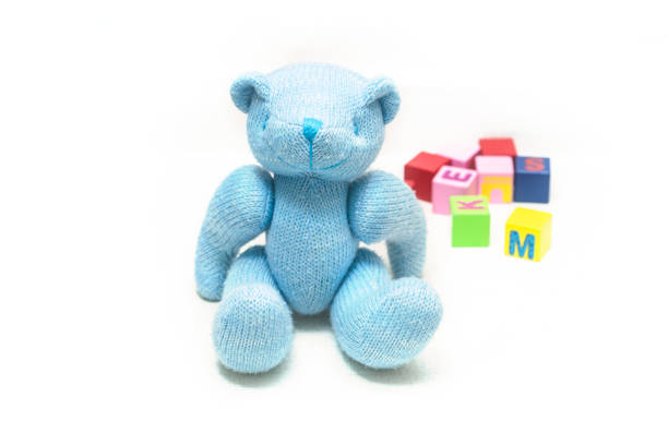 istock A stuffed teddy bear with blocks on a white background. 1187031547