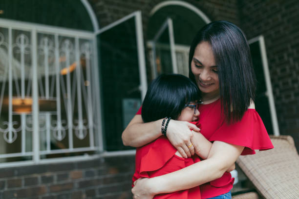 istock Beautiful mother embracing daughter 1187034869